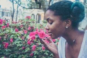 Black woman smells the flowers