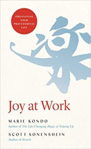 cover of Joy At Work by Marie Kondo:light grey-blue Japanese alphabet character a cream background plus the title of the book in red text