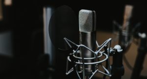a photo of a podcast microphone against a dark background