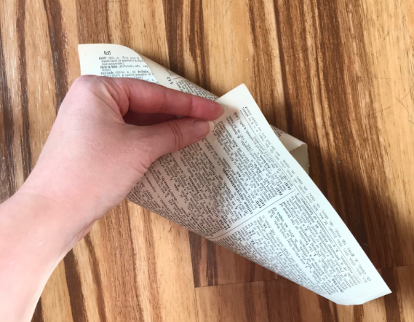 Picture of a dictionary page being rolled into a cone