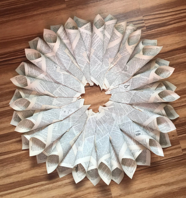 A picture of a book page wreath with two layers and untrimmed edges
