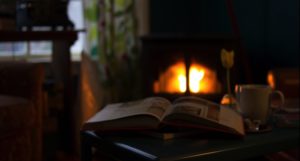 cozy winter scene with fireplace and open book