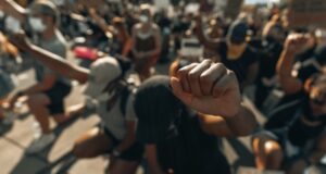 A fist raised in solidarity for George Floyd (IG- @clay.banks)