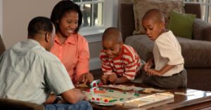 Black family playing monopoly