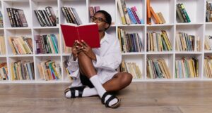 Black woman reading while sitting on the floor