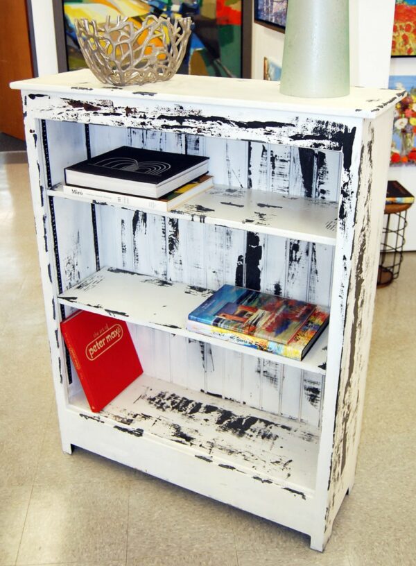 Three tier white wooden bookcase, unevenly painted