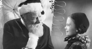a still from Miracle on 34th Street showing Santa and a young girl