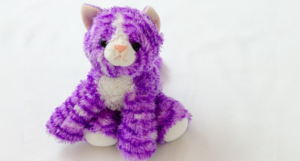 a photo of a purple cat stuffed animal