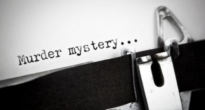 the words "muster mystery..." in black ink typed on white paper on typewriter