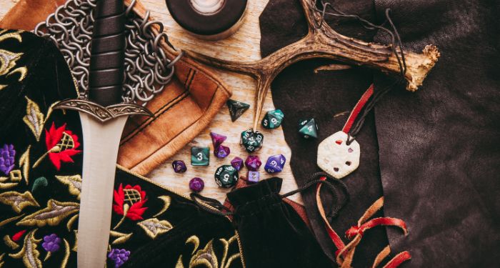Dungeons and Dragons items including die, a fake sword, and other things

