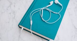image of teal book with headphones on top