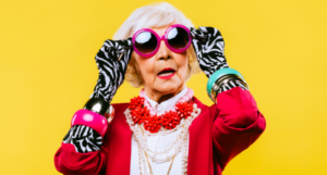 a photo of an older woman wearing large sunglasses and brightly colored clothing