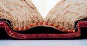 close up view of an open book with a cracked spine