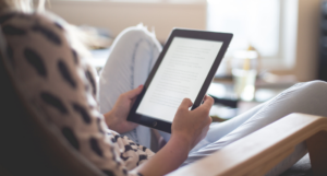 a photo of someone reading on an ereader or tablet