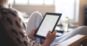 fair-skinned person reading on a tablet