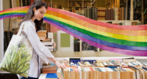 someone browsing a bookstore with a rainbow illustration behind them