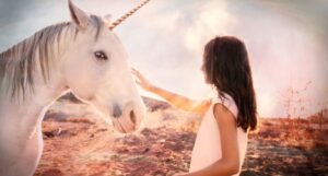 fair-skinned person with long hair reaching out to touch a white unicorn