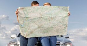 Image of a couple holding a road map
