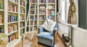 a home library with a cozy armchair and a library ladder