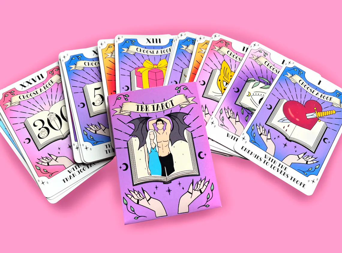 Tarot style cards spread out on a pink background. Each card has an illustration and a reading prompt