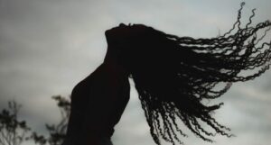 silhouette of a woman flipping her hair