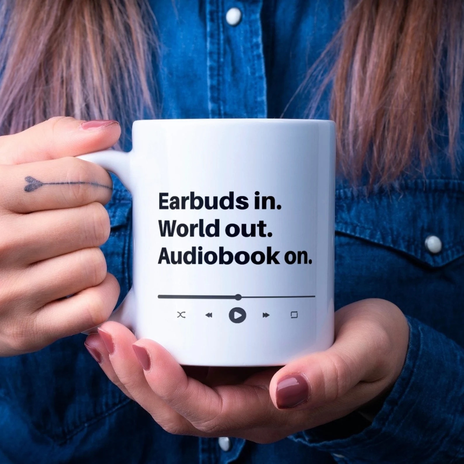a photo of a mug that says, "Earbus In. World out. Audiobook on.