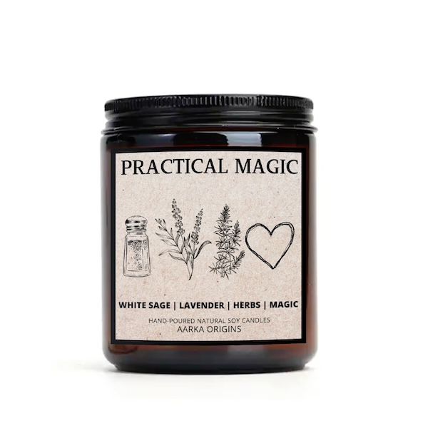 dark blown glass candle with a tan label with graphics of a salt shaker, a spring of rosemary, a spring of lavender, and a heart. Text bordering the graphics reads "Practical Magic, white sage lavender herbs magic"