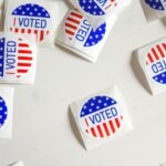 scattered I Voted stickers with American flag design