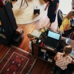 cash register and book seller helping bookstore patrons
