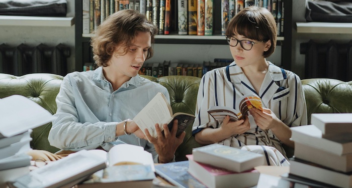 two people discussing a book