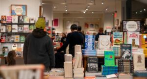 a bookstore table with customers browsing