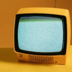 old school tv with a yellow bakground