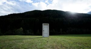 a door in the middle of a field