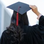 a woman wearing a graduation cap facing away