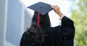 a woman wearing a graduation cap facing away