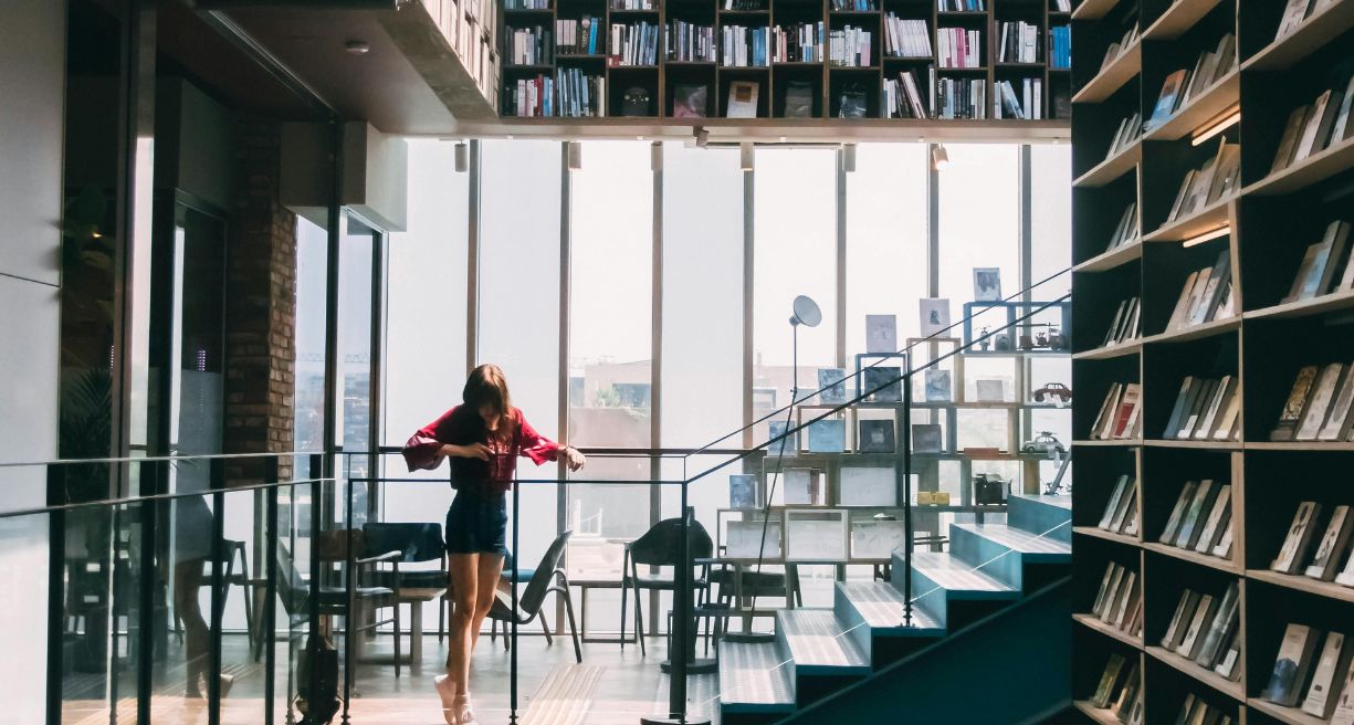 woman in Red Jacket Standing on the Stairs