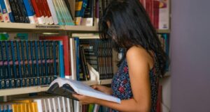 a light brown skinned woman reading