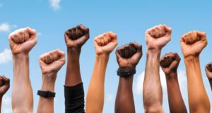 image of raised fists in many different skin tones