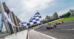 Formula race cars speeding towards the finish line