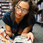 brown-skinned girl reading comic book
