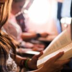 a photo of a woman reading on a plane