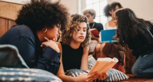 a group of young women of color reading together