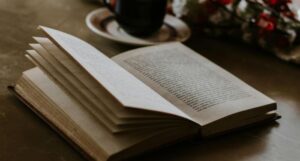 open book near a mug on a table