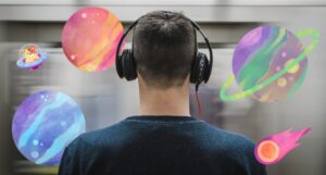 a person listening to headphones with watercolor planets around them