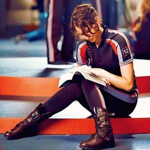 This picture of Katniss (Jennifer Lawrence) reading Harry Potter says it all.