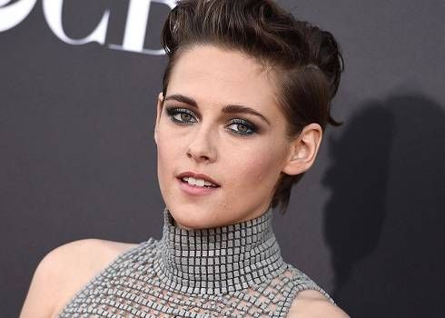 Kristen Stewart in a metallic mesh turtleneck w/ a helmet-style hairdo