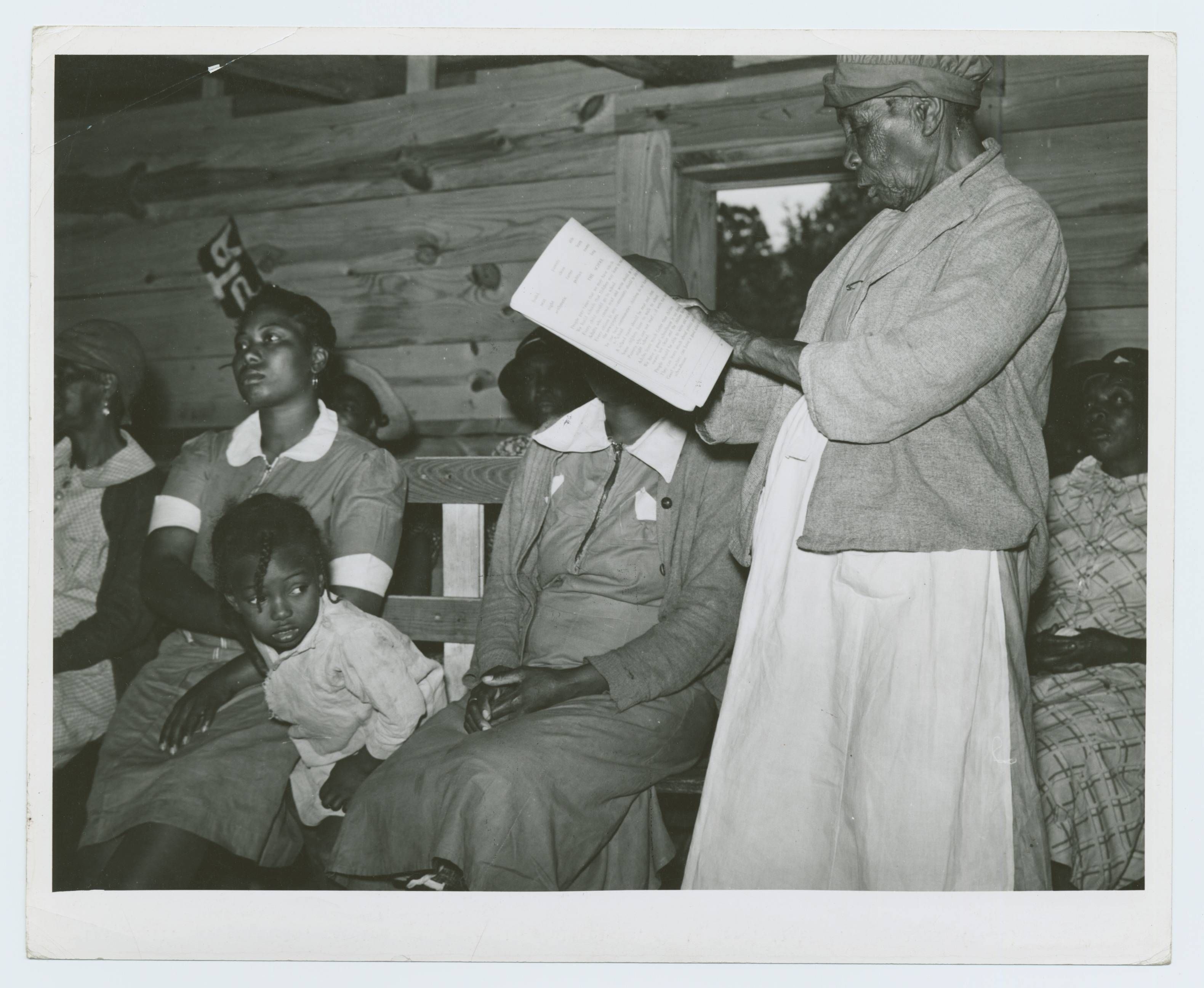 Star pupil, 82 years old, reading her lesson in adult class, Gee's Bend, Alabama, May 1939 - Marion Post Wolcott