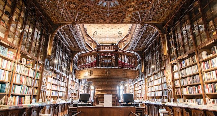 a beautiful bookstore with ornate ceilings and a fancy staircase