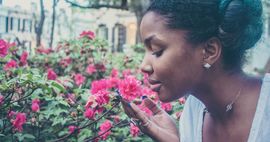 Black woman smells the flowers