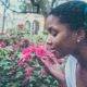 Black woman smells the flowers